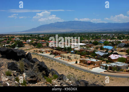 Overlook at the Petroglyph National Monument shows Albuquerque, New Mexico.  Sandia Mountains loom in the background and in the foreground black basal Stock Photo
