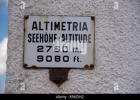 Sign showing the altitude of 2760m or 9080feet on a building in Stevlio town at the top of the Stelvio Pass, one of the Alps Ultra High passes Stock Photo