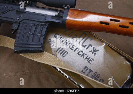 SVD sniper rifle with box of ammunition on canvas background. The inscription translates as 'Snipers Ammunitions' Stock Photo