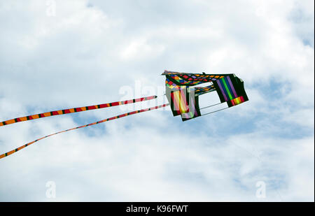 Colorful box kite in flight over  Neshotah Beach Two Rivers, Wisconsin during Kites Over Lake Michigan annual kite festival. Stock Photo