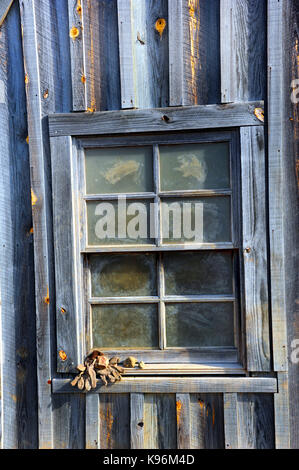 Old pair of gloves sit on the window ledge of the historic mine shaft at the Crater of Diamonds State Park in Arkansas.  Gloves hold diamond hopefuls  Stock Photo