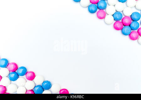 Top view of frame made of colored chocolate coated candy. Isolated on white background. Copy space Stock Photo