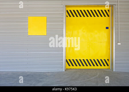 Big Yellow Gate Door at Distribution Warehouse Stock Photo