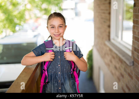 Beautiful little girl with backpack ready back to school Stock Photo