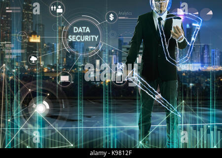Businessman turned into thunder warrior,holding a lightning sword and shield with "DATA SECURITY" word on digital virtual screen.Business security con Stock Photo