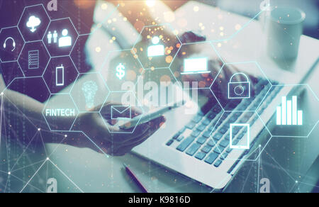 Businessman with fintech icon and internet of things with matrix code background , Investment and financial internet technology concept. Stock Photo