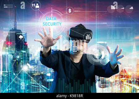 Businessman touching "DATA SECURITY" word on digital virtual screen with both hands. Business security concept . Stock Photo