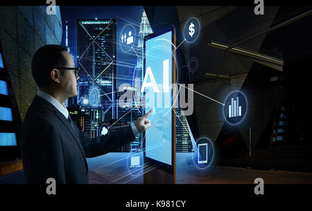 Businessman touching "AI" word on screen of digital booth with fintech infographic. Hi-tech business concept . Stock Photo