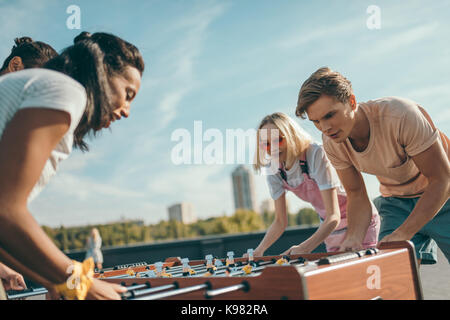 friends playing table football Stock Photo