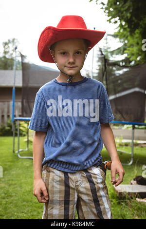 Portrait of cute boy wearing cowboy hat in playground Stock Photo