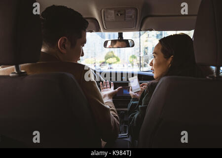 Couple discussing over mobile phone in the car Stock Photo