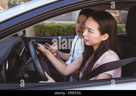 Couple arguing in the car on a sunny day Stock Photo