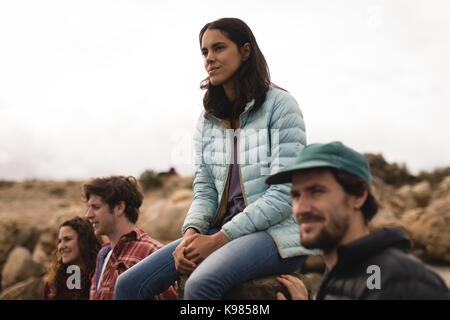 Friends relaxing near lakeside on a sunny day Stock Photo