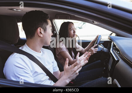 Couple arguing in the car on a sunny day Stock Photo