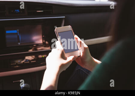 Woman using mobile phone in the car Stock Photo