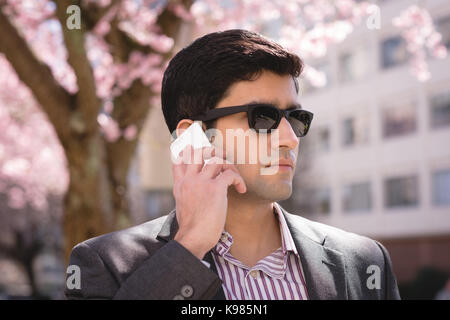 Close-up of businessman talking on mobile phone Stock Photo