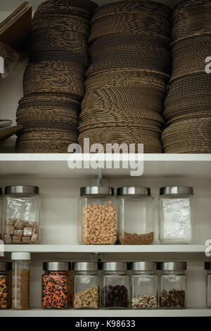 Various ingredient bottles kept in shelf at kitchen Stock Photo