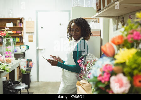 Female florist using digital tablet at his flower shop Stock Photo