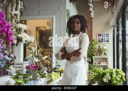 Portrait of female florist with arms crossed at his flower shop Stock Photo