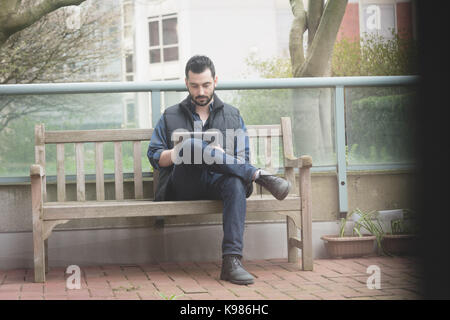 Young man using digital tablet in the garden Stock Photo