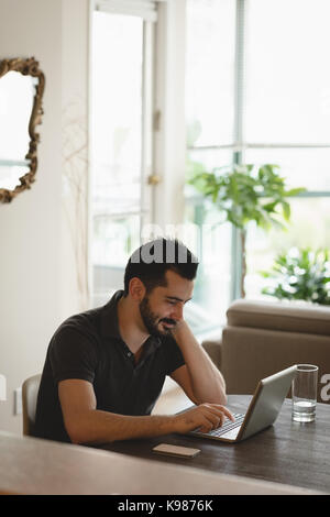 Young man using laptop at home Stock Photo