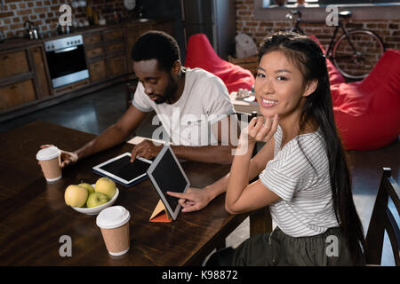 couple using tablets on kitchen Stock Photo