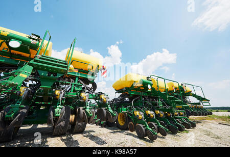 Close up of seeder attached to tractor in field. Agricultural machinery for spring works sowing Stock Photo