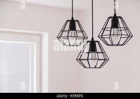 Suspended chandelier in loft style in a modern house interior. Stock Photo