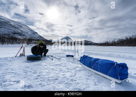 Getting water from the lake, Abisko national park, Sweden, Europe, EU Stock Photo