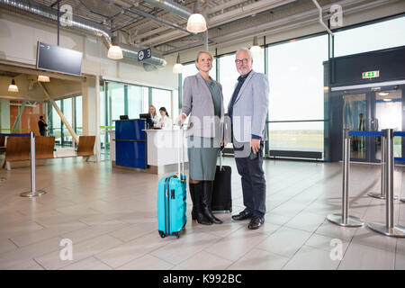 Senior Business Couple Smiling With Receptionists Working In Air Stock Photo