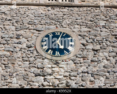 stunning old clock outside on church brick wall ; England; Essex Stock Photo