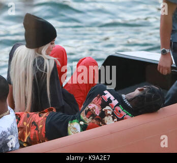 MIAMI, FL - MAY 07: Kylie Jenner goes back to being a blonde (like she was with X-Boyfriend Tyga) seen here are the first pictures of a very 'BLONDE' Kylie Jenner and her new boyfriend Jacques Webster, Jr. better know as hip-hop singer Travis Scott. The lovebirds arrived by yacht and dined in a private back room of the exclusive restaurant the River Yacht Club where Kylie and Travis looked very happy and were spotted kissing and being very romantic while bodyguards kept out unwanted people. The new couple had a blast at the exclusive waterside restaurant where they were joined by Miami-based Stock Photo