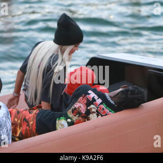 MIAMI, FL - MAY 07: Kylie Jenner goes back to being a blonde (like she was with X-Boyfriend Tyga) seen here are the first pictures of a very 'BLONDE' Kylie Jenner and her new boyfriend Jacques Webster, Jr. better know as hip-hop singer Travis Scott. The lovebirds arrived by yacht and dined in a private back room of the exclusive restaurant the River Yacht Club where Kylie and Travis looked very happy and were spotted kissing and being very romantic while bodyguards kept out unwanted people. The new couple had a blast at the exclusive waterside restaurant where they were joined by Miami-based Stock Photo