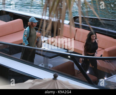 MIAMI, FL - MAY 07: Kylie Jenner goes back to being a blonde (like she was with X-Boyfriend Tyga) seen here are the first pictures of a very 'BLONDE' Kylie Jenner and her new boyfriend Jacques Webster, Jr. better know as hip-hop singer Travis Scott. The lovebirds arrived by yacht and dined in a private back room of the exclusive restaurant the River Yacht Club where Kylie and Travis looked very happy and were spotted kissing and being very romantic while bodyguards kept out unwanted people. The new couple had a blast at the exclusive waterside restaurant where they were joined by Miami-based Stock Photo