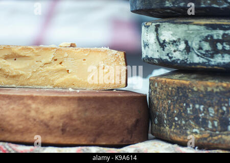 Traditional artisan cheese wheels composition. Stock Photo