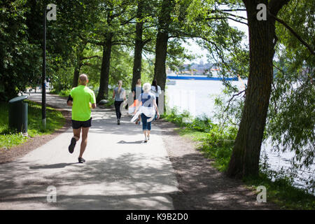 Powerful happy elderly people are walking, running in the park Stock Photo