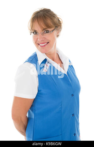 Portrait of happy mature female janitor standing against white background Stock Photo