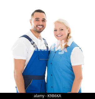 Portrait of happy male and female janitors standing isolated over white background Stock Photo