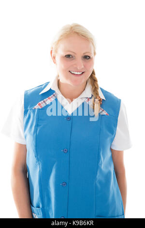 Portrait of happy mature female janitor standing against white background Stock Photo