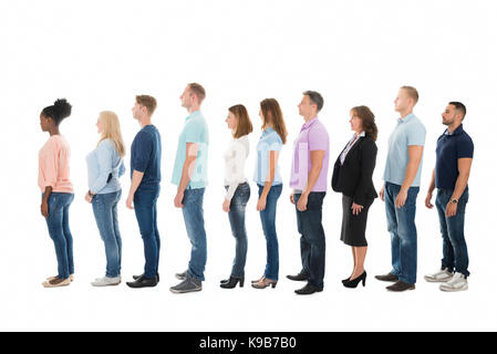 Full length side view of creative business people standing in row against white background Stock Photo