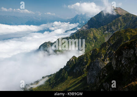 Beautiful clouds and fog among mountain landscape. Stock Photo