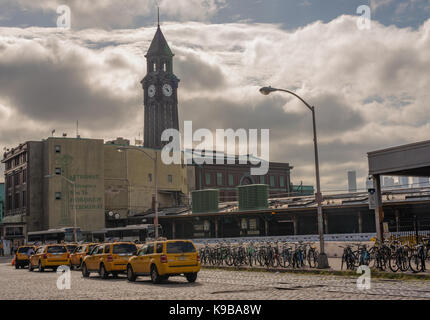 Hoboken , NJ USA -- September 19, 2017 -- Taxi cabs and bikes lines up outside the  Hoboken train station and clock tower. Editorial Use Only. Stock Photo