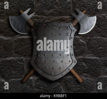 metal medieval fantasy shield and two crossed axes on stone wall Stock Photo
