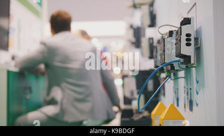 People working in high-tech industry room near electronic equipment Stock Photo