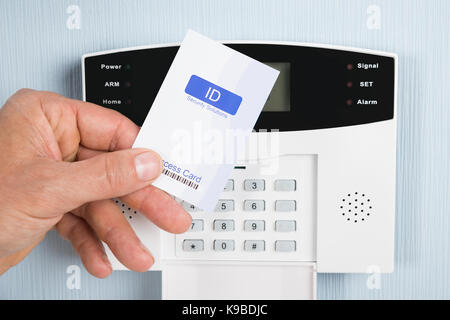 Close-up Of A Person Holding Security Card To Open Door. Photographer owns copyright for card design Stock Photo