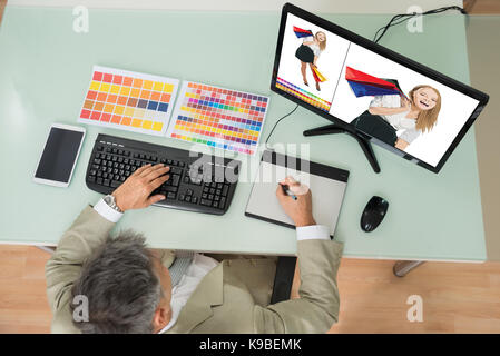 High Angle View Of Businessman Sketching On Graphic Tablet. Photographer owns copyright for images on screen Stock Photo