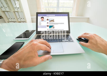 Close-up Of A Person Chatting On Social Website In Office. Photographer owns copyright for images on screen Stock Photo