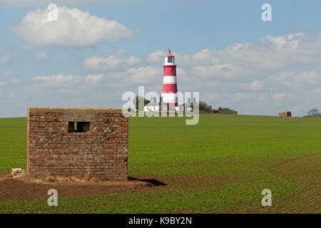 Two military war time Pillbox guard posts in an agricultural field at Happisburgh, Norfolk, England, UK Stock Photo