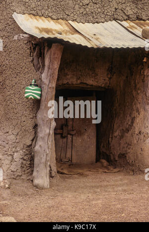 Samatiguila, Ivory Coast, Cote d'Ivoire. South Entrance to rhe Oldest Mosque in Cote d'Ivoire, in Malinke Style.  A Kettle Holding Water for Ablutions Hangs by the Door. Stock Photo