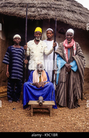 Samatiguila, Ivory Coast, Cote d'Ivoire.  Village Muslim Elders with one of the Weapons of Samori Toure, who resisted French Incursions in the late 19th. Century. Stock Photo